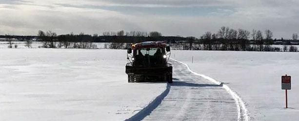 snowmobile trail grooming first pass on open field